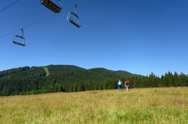 Bir çift turist dağ yolunda yürüyüşe çıkıyor.