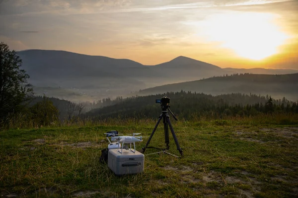 Silhouette Drone flying on mountain sunrise sky with cloud, Aerial photography. mountains landscape with sun and alpine pines. Sunrise