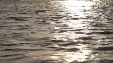 Güneş gün batımında suya yansıyor.