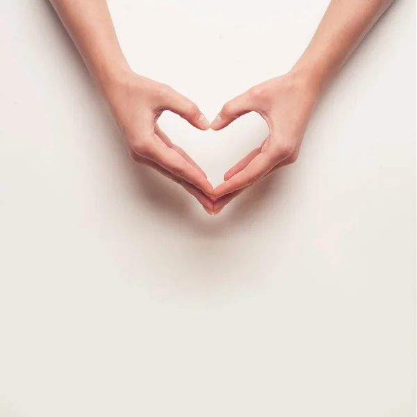 Man and woman hands shows heart gesture — Stock Photo, Image