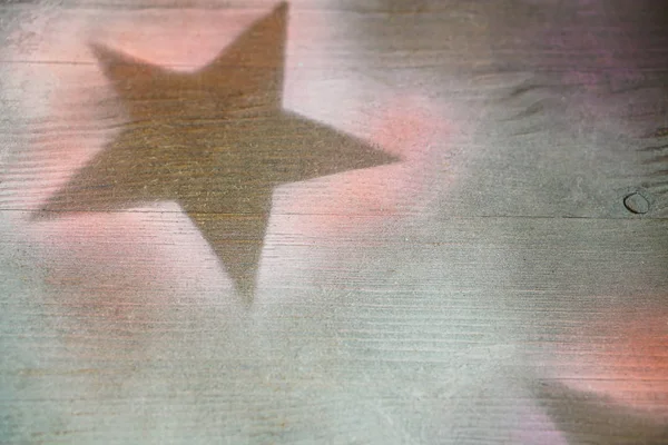 Wooden surface with painted stars silhouettes Background design