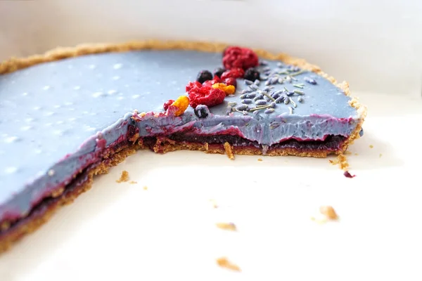 Cut homemade cake decorated with freeze- dried berries — Stock Photo, Image