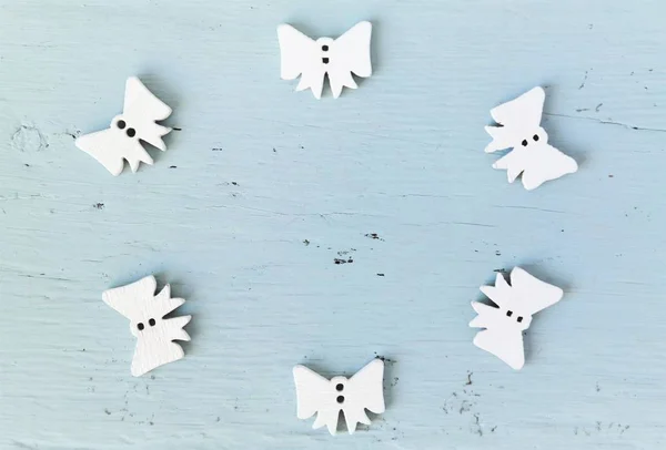 rustic christmas or wedding background with a group of little white angels and copy space