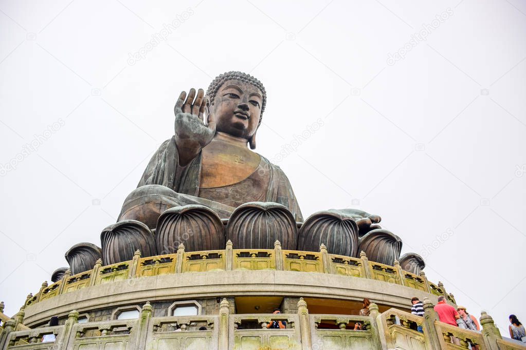 The enormous Tian Tan Buddha sitting on lotus statue up on high mountain near Po Lin Monastery, Lantau Island, Hong Kong