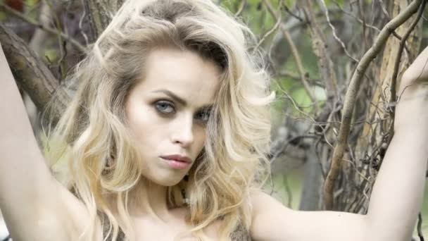 Close up portrait of beautiful young woman hand through hair blowing in wind forest — Stock Video