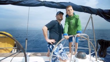 Baba oğlu yat yönlendirmek için öğretir. Genç Kaptan