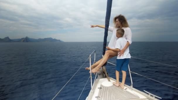 Freedom of the ocean for healthy family on outdoor Summer vacation sailing on luxury yacht. Mother and son — Stock Video