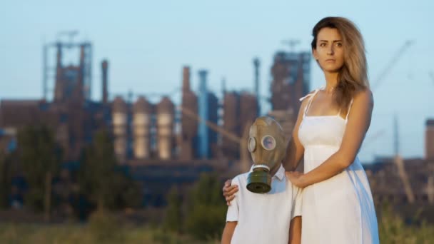 Mom And Son In A Gas Mask Stand In The Background Of A Factory And Smoking Mom And Son In A Gas Mask Stand In The Background Of A Factory And Smoking