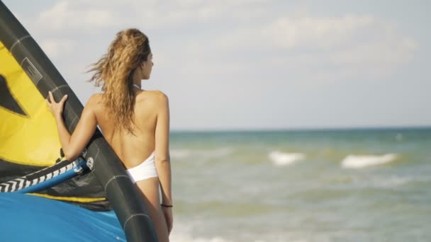 Young woman with flying kite on tropical beach at sunset. Girl holding kite in hand — Stock Video