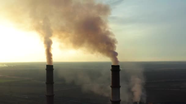 La zone industrielle avec un grand tuyau rouge et blanc épaisse fumée blanche est versée du tuyau d'usine contrairement au soleil. Pollution de l'environnement : une pipe à fumée. Vue aérienne — Video