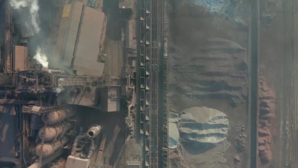 Aerial view over industrialized city with air atmosphere and river water pollution from metallurgical plant near sea. Dirty smoke and smog from pipes of steel factory and blast furnaces. — Stock Video