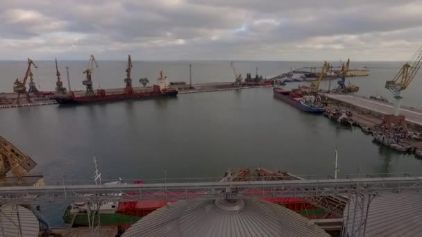 Aerial view of big grain elevators on the sea. Loading of grain on a ship. Port. Cargo ship — Stock Video