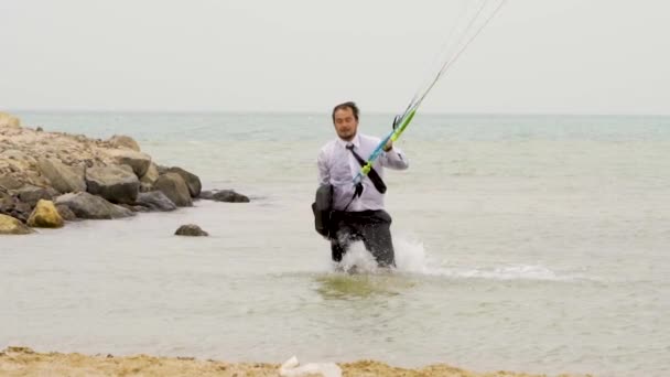 Businessman running out the sea in slow motion — Stock Video