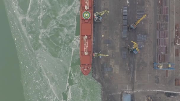 Aerial 4k UHD footage Cargo freight ship with working crane bridge in shipyard for Logistic Import Export background , top view — Stock Video