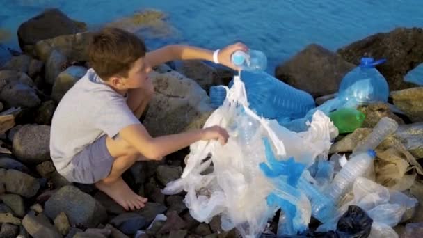 Litle child volunteer cleaning up the beach at the sea. Safe ecology concept. — Stock Video