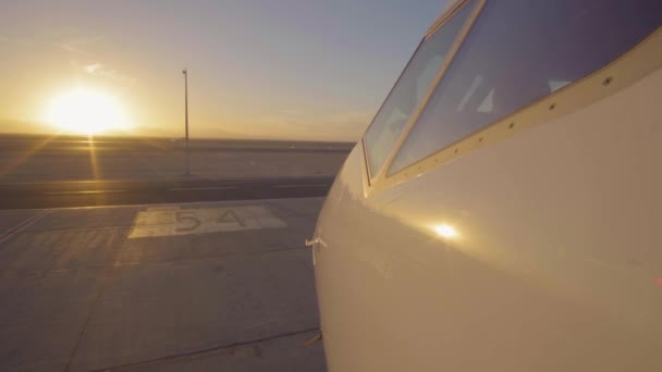 Aereo jet in pista aeroporto come silhouette di fronte al grande tramonto 4K UltraHD — Video Stock