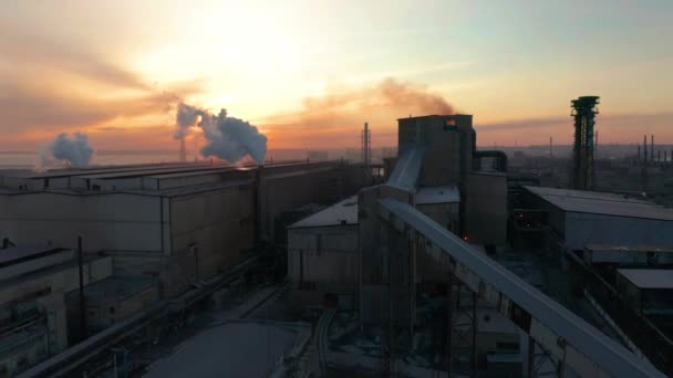 Industrial zone with a pipes thick white smoke aerial view. Beautiful sunset skyline at background — Stock Video