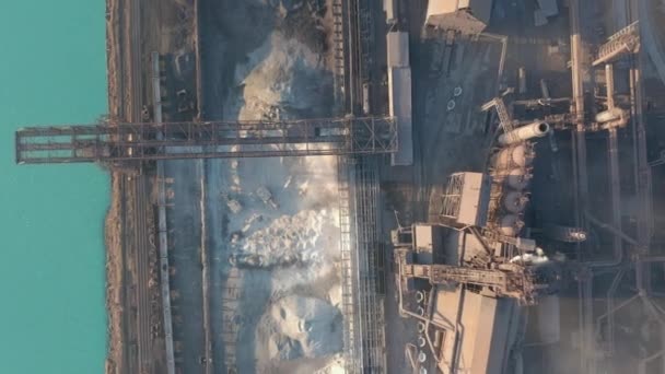Aerial view over industrialized city with air atmosphere and river water pollution from metallurgical plant near sea. Dirty smoke and smog from pipes of steel factory and blast furnaces. Ecological — Stock Video