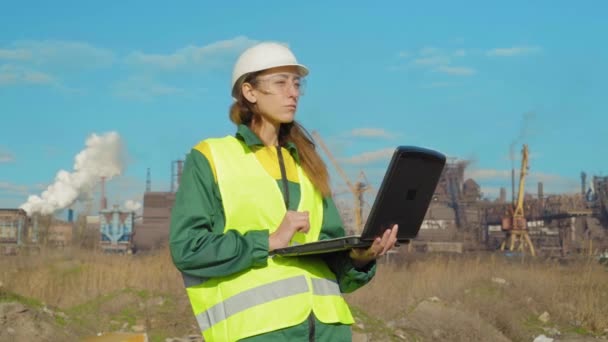 The young female engineer, worker at work location works — Stock Video