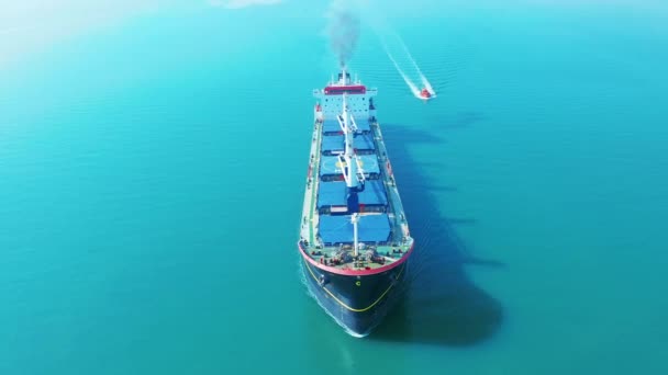 AERIAL VIEW: Flying over massive ship filled moving in the quiet sea. Cargo being moved by large international cargo ship to final destination. — Stock Video