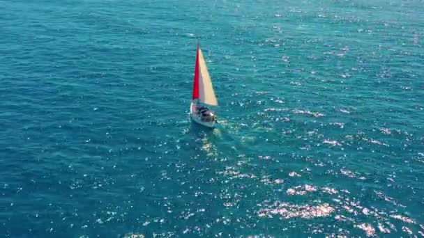 Aerial view. Sailing yacht with red sail in the open Sea. — Stock Video