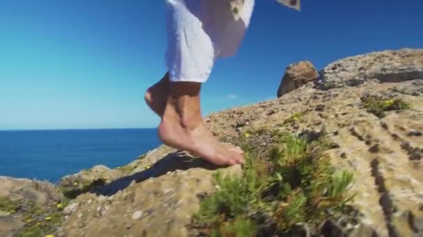 Bare female legs walking feets on rocky terrain. — Stock Video