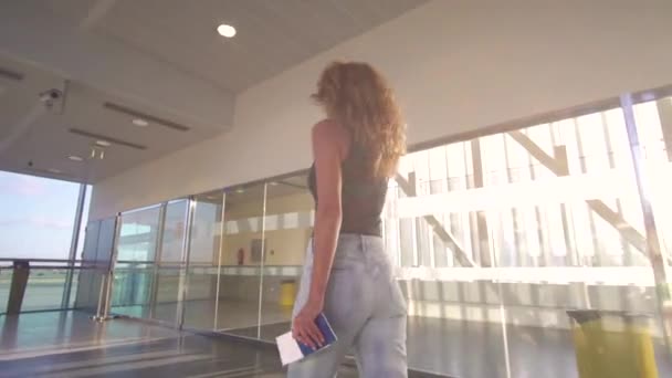 Girl going to the airplaine, go in the terminal at the airport, holding passport and ticket. — Stock Video