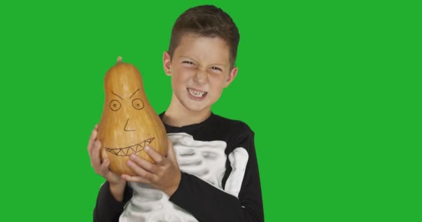 Little boy wearing costume with a pumkin for Halloween party against chroma key green screen background. — Stock Video