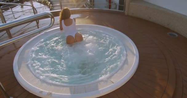 Young, attractive, nice, beautiful, sexy woman swims in the jacuzzi. — Stock Video