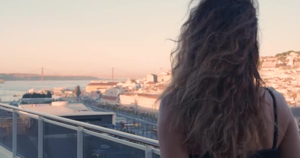 Donna felice che cammina sul balcone con vista sulla città Lisbona, Portogallo. Retrospettiva della giovane sullo sfondo di Lisbona . — Video Stock