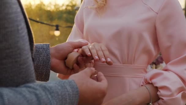 Groom puts the wedding ring on Bride. — Stock Video