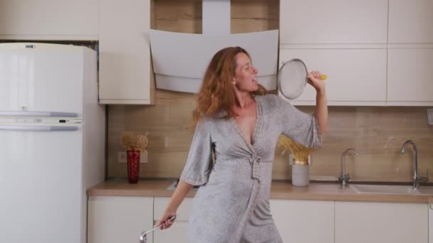 Pregnant lady in bathrobe dancing and sing in the kitchen. — Stock Video