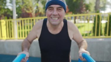 Emekli yaşlı bir adam dışarıda spor salonunda çalışıyor. Sağlıklı yaşam tarzı kavramı.