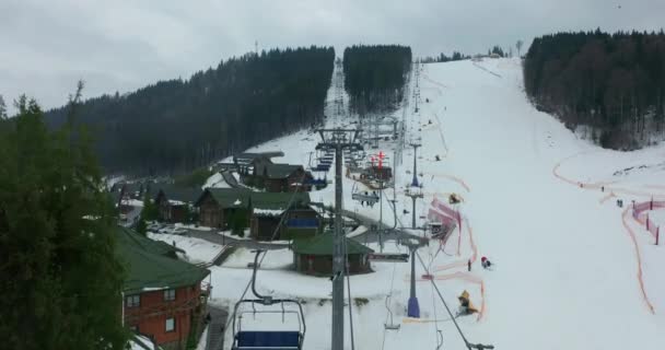 Widok z lotu ptaka na wyciąg narciarski dla narciarzy i snowboardzistów na śnieżnym stoku narciarskim. — Wideo stockowe