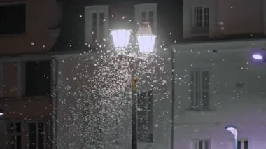 Night butterflies and insects dance around the lanterns at summer night.