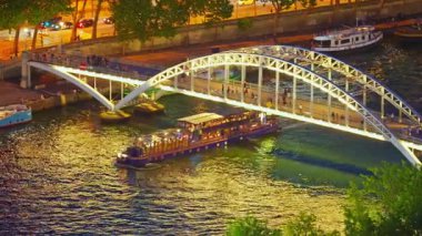 View from above of the famous bridge over the Seine River. Paris city center in summer.