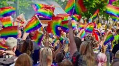 Copenhagen, Denmark - August 16, 2025 : Lgbt pride parade. Same love concept. Dressed up bi men wear rainbow flag. Rainbow flag at pride parade celebrates LGBTQ community.