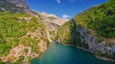 People on boats, catamarans and canoes explore Verdon Gorge at summer. France.