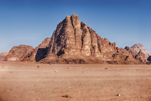 In the Wadi Rum Desert of Southern Jordan, the landscape is dominated by the cliffs and buttresses of the mountain of the Seven Pillars.
