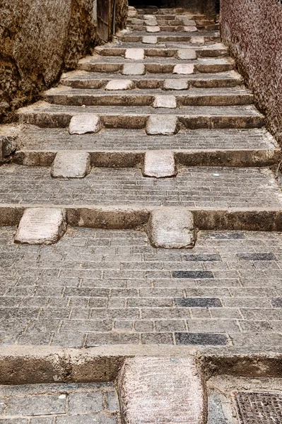 Steps in the narrow alleys of the old city medina often have ramps placed to facilitate the movement of hand carts up and down the hillside in Fes, Morocco.