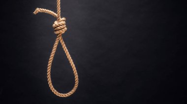 Noose. The concept of murder or suicide. On dark background. clipart