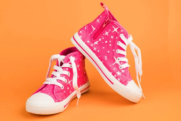 stock image Red children's shoes. On orange background