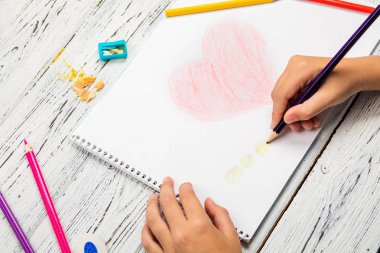 Kırmızı kalp ahşap masa üzerinde white paper renkli kalemle çizim çocuklar kontrolden