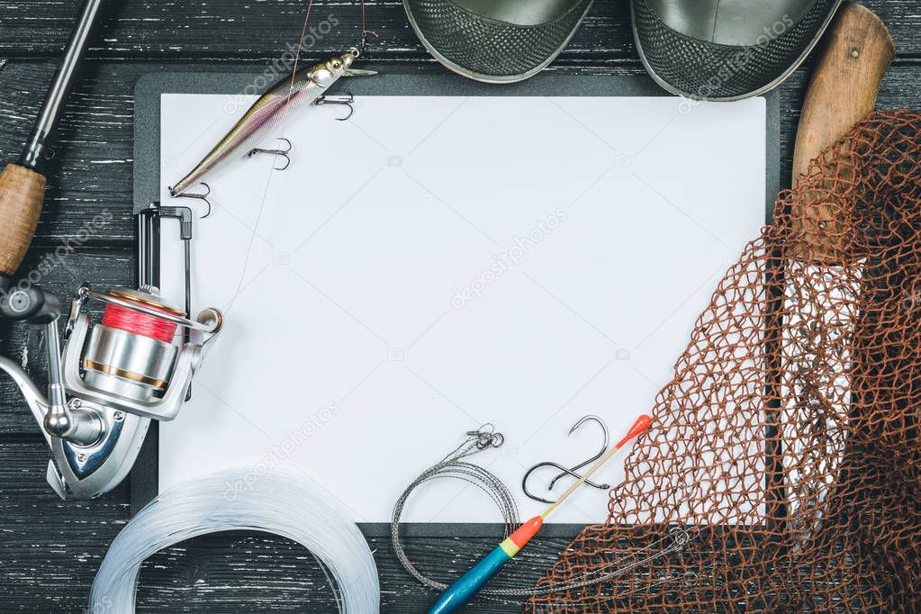 Fishing gear - fishing, fishing, hooks and baits, an old sheet of paper on a wooden background.