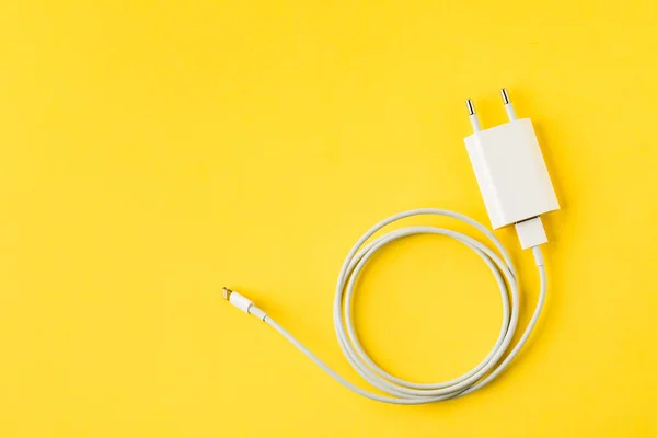 white cable for phone yellow background