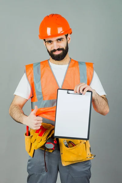 Builder Orange Helmet Gray Background Signs Something — Stock Photo, Image