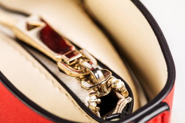 Metal zipper on intense red leather jacket or close-up macro wallet.
