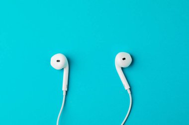 Headphones on blue background. The concept of music.
