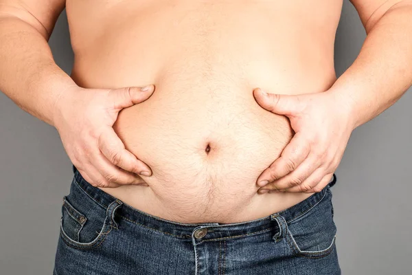 fat man, checking his weight, on a gray background