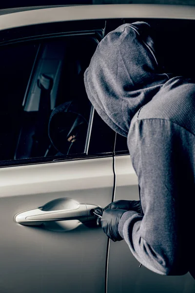 A man with a Balaclava on his head tried to break into the car.